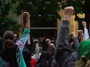 FILE: Protesters gather at the Seattle Police Department's West Precinct after marching from the police-free zone known as the Capitol Hill Organized Protest (CHOP) on June 15, 2020 in Seattle, Wash.