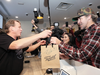 File – Bruce Linton, left, then-CEO of Canopy Growth sold Canada’s first legal, recreational cannabis to Nikki Rose and Ian Power at the Tweed shop in St. John’s at 12:01 am NDT on Oct. 17, 2018. PAUL DALY/THE CANADIAN PRESS