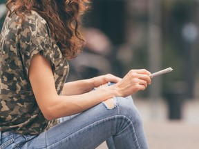 Close-up of a girl with cannabis cigarette