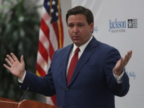 FILE Florida Gov. Ron DeSantis speaks at a new conference on the surge in coronavirus cases in the state held at the Jackson Memorial Hospital on July 13, 2020 in Miami, Fla.