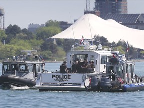 Marine units from the RCMP, left, OPP, centre, and Windsor Police Service are shown on the Detroit River near downtown Windsor on May 26, 2020, during a search for a person who jumped in the river.