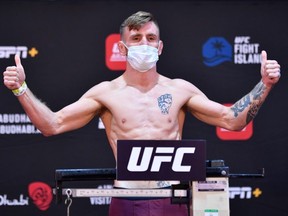 In this handout image provided by UFC, Tim Elliott poses on the scale during the UFC Fight Night weigh-in inside Flash Forum on UFC Fight Island on July 14, 2020 in Yas Island, Abu Dhabi, United Arab Emirates.