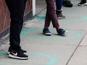 File - People stand in freshly painted circles, six-feet-apart, as they wait in a two-hour line to buy cannabis products from Good Chemistry on March 23, 2020 in Denver, Colorado. Photo: by Michael Ciaglo/Getty Images