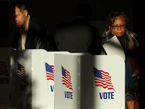 Voters cast their ballots at a polling place at Highland Colony Baptist Church, November 27, 2018 in Ridgeland, Mississippi.