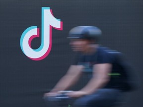 FILE: A bicyclist rides past an advertisement for social media company TikTok on Sept. 21, 2020 in Berlin, Germany.