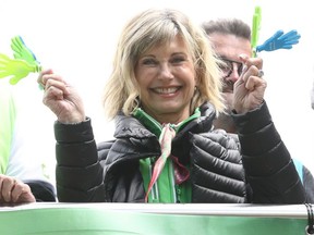 FILE: Olivia Newton-John encourages walkers during the annual Wellness Walk and Research Runon September 16, 2018 in Melbourne, Australia. The annual event, now in it's sixth year, raises vital funds to support cancer research and wellness programs at the Olivia Newton-John Cancer Wellness and Research Centre in Victoria.