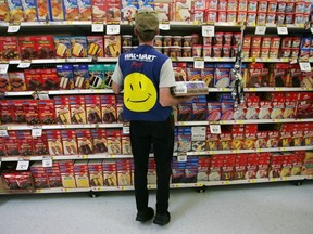 TROY, OH - MAY 11: An employee restocks a shelf in the grocery section of a Wal-Mart Supercenter May 11, 2005 in Troy, Ohio.