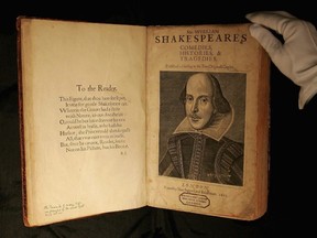 A Sotheby's employee handles a copy of William Shakespeare, The First Folio 1623 on July 7, 2006 in London, England.
