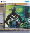 The building’s exterior features a 30-by-80 foot mural of Kemp in Sonics’ green, painted by Seattle artist Jeff Jacobson, AKA Weirdo. / Photo: WeirdoCult Instagram
