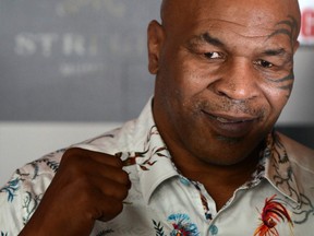 FILE: Former US boxer Mike Tyson poses during a news conference to announce India's first global mixed martial arts Kumite 1 league in Mumbai on Sept. 28, 2018. /
