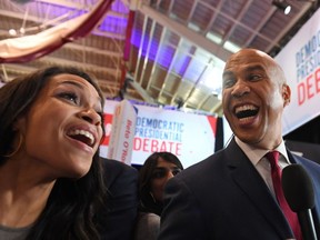 FILE: U.S. actress Rosario Dawson (L) and boyfriend Democratic presidential hopeful New Jersey Senator Cory Booker speak with the press in the spin room after the fourth Democratic primary debate of the 2020 presidential campaign season co-hosted by The New York Times and CNN at Otterbein University in Westerville, Ohio on Oct. 15, 2019.