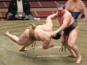FILE: Image for representation. Yokozuna-ranked sumo wrestler Hakuho (R) pushes down opponent Kagayaki in the ring during their match on the 8th day of the 15-day July Grand Sumo Tournament at Tokyo's Ryogoku Kokugikan on July 26, 2020. /