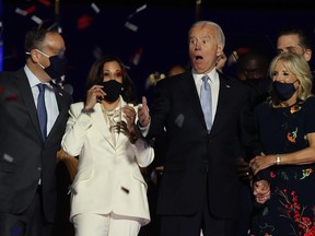 FILE: President-elect Joe Biden, Jill Biden, Vice President-elect Kamala Harris and husband Doug Emhoff react on stage after Biden's address to the nation from the Chase Center November 07, 2020 in Wilmington, Del.