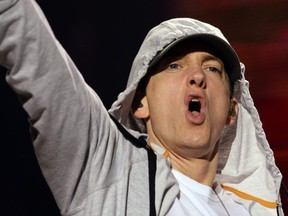 FILE: U.S. rapper Eminem performs on Aug. 22, 2013 during a concert at the Stade de France in Saints-Denis, near Paris. /