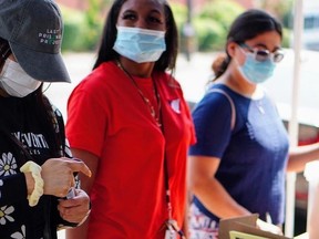 Members of the Last Prisoner Project take part in a community drive in L.A. to secure sanitation and hygiene supplies for vulnerable communities. /