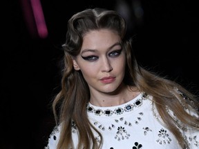 U.S. model Gigi Hadid presents a creation for Miu Miu during the Women's Fall-Winter 2020-2021 Ready-to-Wear collection fashion show in Paris, on Mar. 3, 2020. /