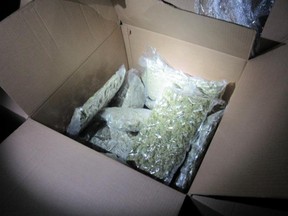 Officers found vacuum-sealed bags containing suspected cannabis that later field tested as positive for properties of weed. /