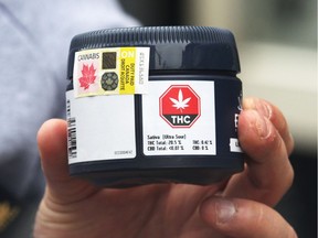 FILE - A customer shows their purchase at J. Supply Co., Windsor's first cannabis retail store located in the heart of the downtown, on Saturday Mar. 29, 2020. /