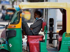FILE: Image for representation. An auto-rickshaw driver rests as he waits for passengers after the government eased restrictions imposed as a preventive measure against the spread of the COVID-19 Coronavirus in New Delhi on May 19, 2020. /