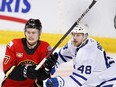 FILE: Toronto Marlies player Calle Rosen, rt, from Sweden, battles with Stockton Heat player Connor Zary during AHL (American Hockey League) hockey action in Calgary, Alta., on Sunday Feb. 21, 2021. /