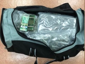 Officers located about seven kilograms of cannabis and just shy of $12,000 in cash inside the hockey bag. /