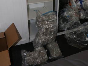 The police search cash totalling about AU$65,000, a money counter, a Cryovac machine, a mobile phone and approximately 10 kilograms of cannabis contained in vacuumed-sealed bags. /