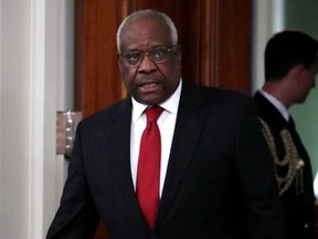 FILE: U.S. Supreme Court Associate Justice Clarence Thomas arrives for the ceremonial swearing in of Associate Justice Brett Kavanaugh in the East Room of the White House Oct. 08, 2018 in Washington, D.C. /