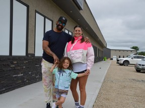 Sean Stewart, Chryslin Friesen, seen here with their son Sunshine at the site at 555 Traverse Rd. in Ste. Anne, where they plan to open AAAAA Supercraft Cannabis on June 25.