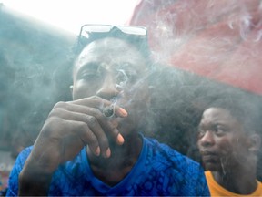A man smokes cannabis in Lagos, on November 11, 2019.