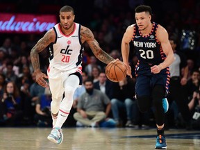 FILE: Gary Payton II #20 of the Washington Wizards drives past Kevin Knox II #20 of the New York Knicks during the first half of their game at Madison Square Garden on Dec.  23, 2019 in New York City. /