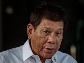 FILE: Philippine President Rodrigo Duterte delivers a speech as he witnesses the arrival of a shipment of Sinovac Biotech COVID-19 vaccines at Ninoy Aquino International Airport on February 28, 2021 in Manila, Philippines.