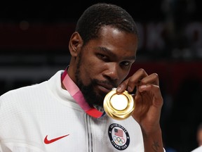 FILE: Kevin Durant of Team United States poses for photographs with his gold medal  during the Men's Basketball medal ceremony on day fifteen of the Tokyo 2020 Olympic Games at Saitama Super Arena on August 07, 2021 in Saitama, Japan. /