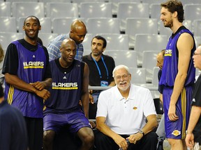 FILE: (From L) Los Angeles Lakers' Kobe Bryant, Lamar Odom, coach Phil Jackson and Paul Gasol from Spain chat during training session on October 6, 2010 at Palau Sant Jordi in Barcelona. /