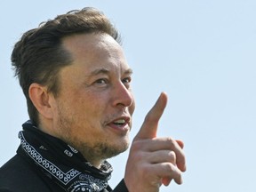 FILE: U.S. entrepreneur and business magnate Elon Musk gestures during a visit at the Tesla Gigafactory plant under construction, on Aug. 13, 2021 in Gruenheide near Berlin, eastern Germany. /