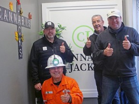 FILE: Cannabis Jacks owners Tom Laronde, left, John Shelegey, kneeling, and Steve Beaudry, right, give a thumbs-up with founder Mike Birch, Thursday, at the business's official opening on Cassells Street. /