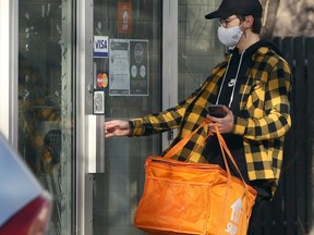 FILE: A Skip The Dishes driver enters Wako Sushi Cafe on Corydon Avenue in Winnipeg on Wed., Jan. 13, 2021. /