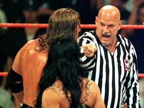 FILE: Minnesota Governor and former professional wrestler Jesse Ventura (R) points during an argument with wrestler Triple H (L) and Chyna (C), who left the ring soon after, Aug. 22, 1999 in Minneapolis, Minn. /
