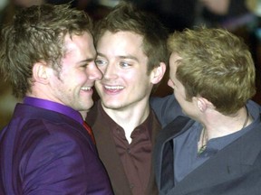 FILE: Elijah Wood (c) who plays Frodo Baggins in the "Fellowship of the Rings", the first Instalment of the Trilogy "Lord of the Rings", is greeted by two of the Hobbits at the World Premier 10 Dec. 2001, in London's Leicester Square. /