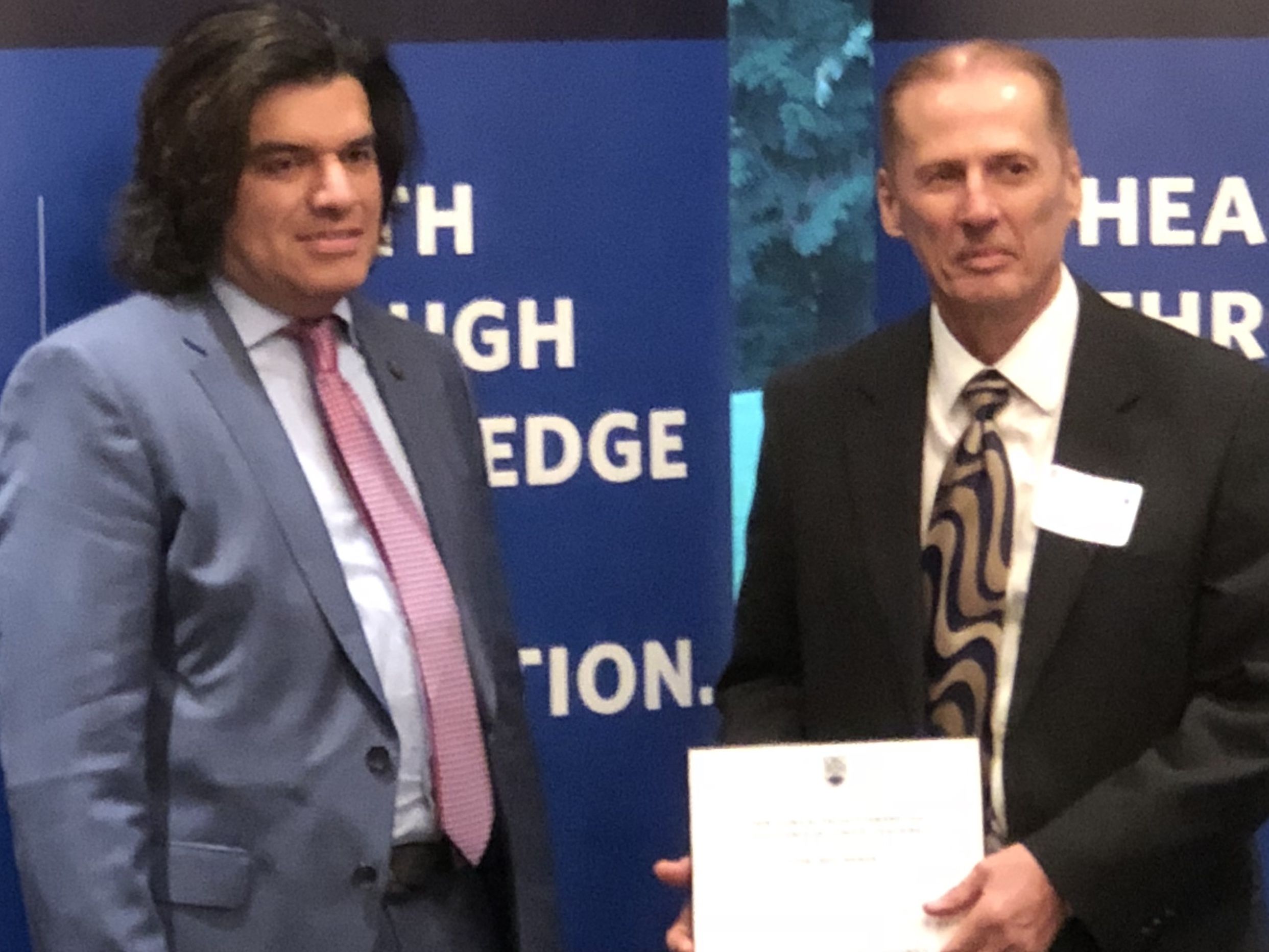 Dr. Neil Hanon (right) receives a Clinical Faculty Award for Excellence in Clinical Teaching from UBC in 2018.