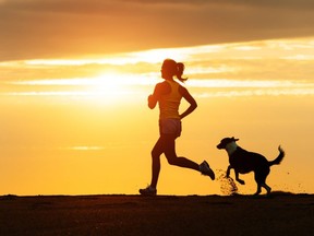 A woman running with her dog