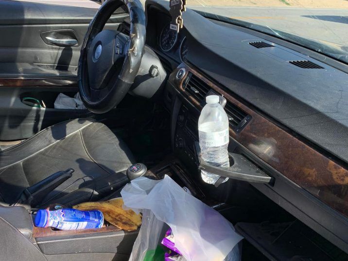  An officer reaching the sedan could see a mess of snacks and trash in the front seat of the car. /