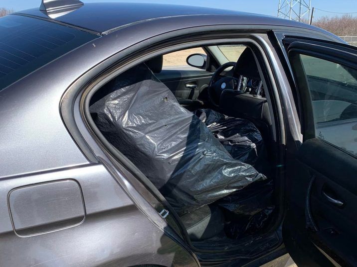  In the back seat of the vehicle, officers could see trash bags that ended up being filled with cannabis. /