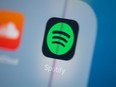 FILE: This illustration picture taken on July 24, 2019 in Paris shows the logo of the Swedish music streaming application Spotify on the screen of a tablet. /