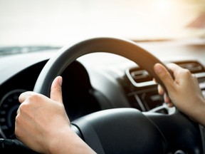 A close-up of a person driving a car.