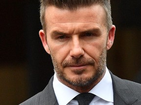Former England international footballer David Beckham leaves Bromley Magistrates Court in Bromley, south-east of London on May 9, 2019, after being disqualifeid from driving for six months for driving while using a mobile phone. /