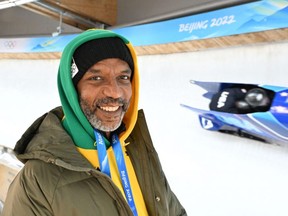 FILE: Jamaican former bobsleigh Olympian Chris Stokes, whose story was the basis of the film "Cool Runnings," poses for a photo by the track as the 2-man bobsleigh training takes place at the Yanqing National Sliding Centre during the Beijing 2022 Winter Olympic Games in Yanqing on Feb. 10, 2022. /