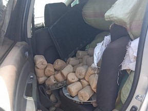 After stopping the vehicle, however, a police search revealed “over six sacks packed with stones of bhang.” /