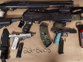 Five men from Prince Albert and Saskatoon are facing a total of 100 charges between them after a number of weapons and other items — including two loaded handguns, a BB gun, shotgun, a baggie of pills, ammunition, cannabis and a small quantity of cash — were seized in Prince Albert on March 9, 2022.