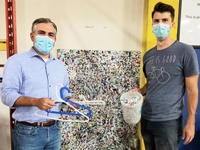 Mortimer Capriles and Saban with a plastic sheet created with plastic flake at the Goodwill Impact Centre in Edmonton.