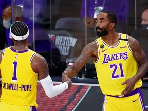 FILE - Sep 18, 2020; Lake Buena Vista, Florida, USA; Los Angeles Lakers guard Kentavious Caldwell-Pope (1) and guard JR Smith (21)  shake hands during the fourth quarter in game one of the Western Conference Finals of the 2020 NBA Playoffs.